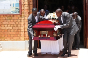 Uganda Funeral Services team carry the casket back to the van shortly after the mass.