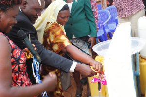 NWSC Entebbe Area General Manager Jackson Turyahurira with Baita Branch Manager Barbara Tugume (green jacket) and Katabi Town Council Women Councilor Amina Malishal officially commission the Public Stand Pipes.