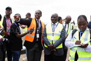 CAA Eng. Ngobi Herbert (L) explains some of the expansion Entebbe Airport expansion projects to Works State Minister Gen. Katumba Wamala.