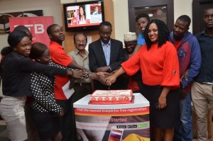 DTB Staff cut a cake to mark the customer service week 2018