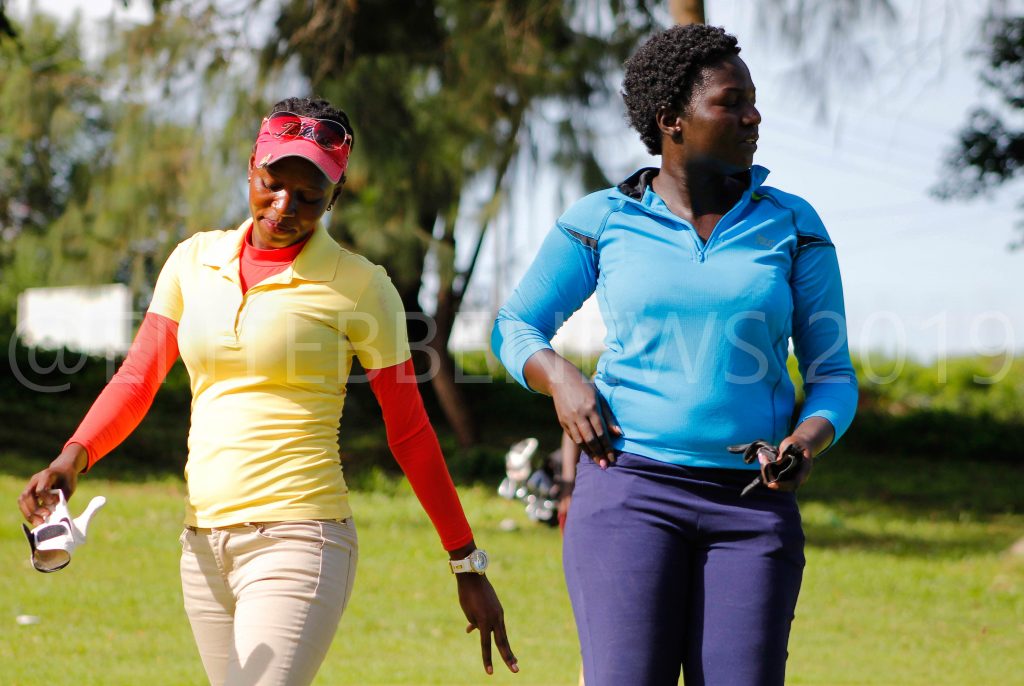 Dejected Martha Babirye (L) and Moureen Okura after they were knocked out of the Singleton Match Play Quarterfinal Round on Wednesday.