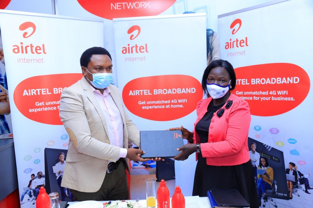 Airtel Uganda General Manager, Broadband, Brenden Kachenje (left) handing over a token Lira Deputy Town Clerk, Rebecca Acen