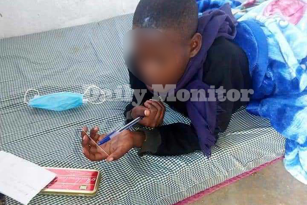 This photo taken on March 31, 2021 shows the 13-year-old girl writing her mathematics paper. PHOTOS/ SADAT MBOGO (Daily Monitor)