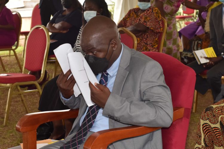 Museveni wants the number of disabled people in the country reduced One of the PWDs peruses through a document during the event at State House Entebbe.