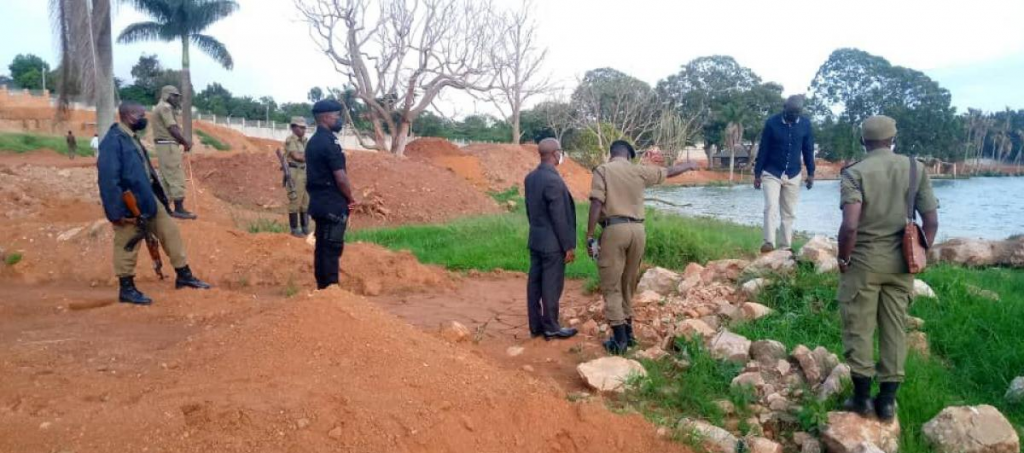 officers checking on soil that was dumped in lake victoria