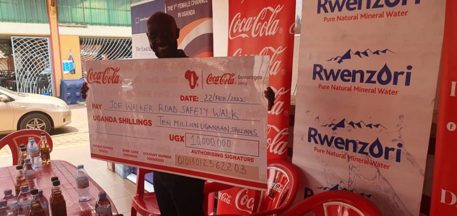 Joseph Beyanga holding a placard of the donation received from CCBA