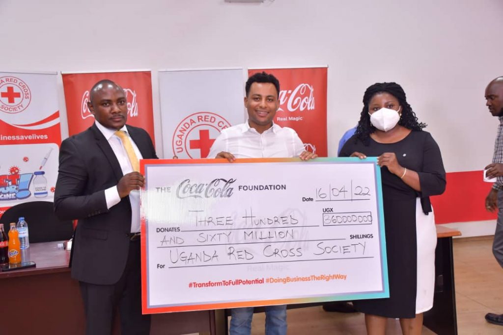 The Coca-Cola Foundation partners with Uganda Red Cross Society to Drive COVID-19 Vaccine Uptake Naphtal Baguma Director Supply Chain Management at the Uganda Red Cross Society Melkamu Abebe General Manager Coca-Cola Beverages Africa and Irene Nakasiita Head Co (002) (1)