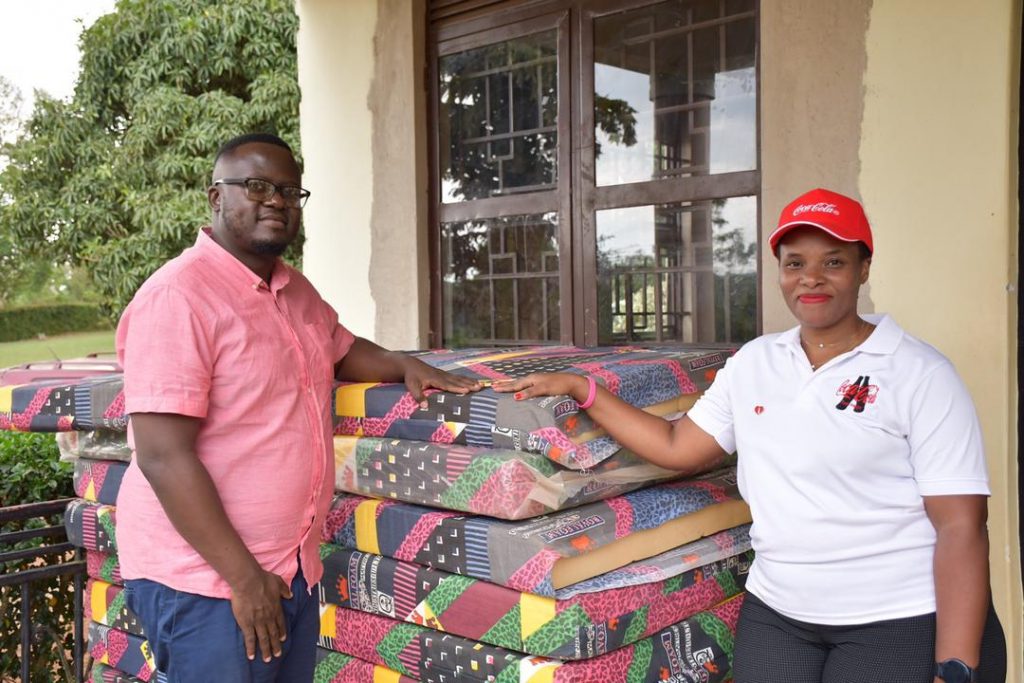 Uganda Police applauds Coca-Cola Beverages Africa for its Community/people Centered Agenda. Kenneth Nganda CEO of Heart of a Child Care Home while recieving Items from Phionah Nahabwe, CCBU Representative 2