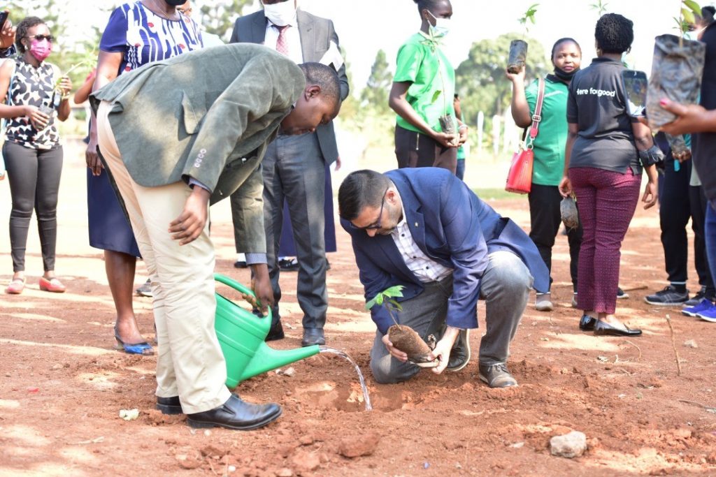 CEO of Standard Chartered Bank Uganda Sanjay Rughani plants a tree at Gayaza High School
