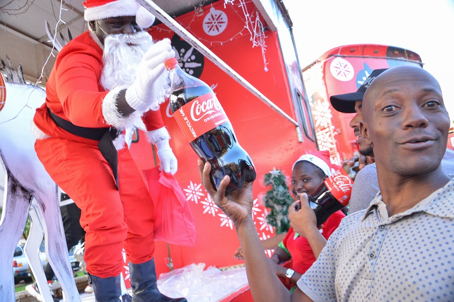 Paul recieving his share of Christmas gift from Coca-Cola