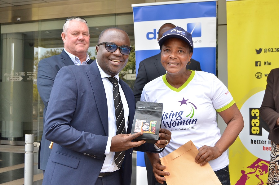 Robert Wanok, Head Personal and Business Banking at dfcu Bank alongside one of the top 10 winners of the dfcu Rising Woman Initiative, before they embarked on a study tour to Nairobi.