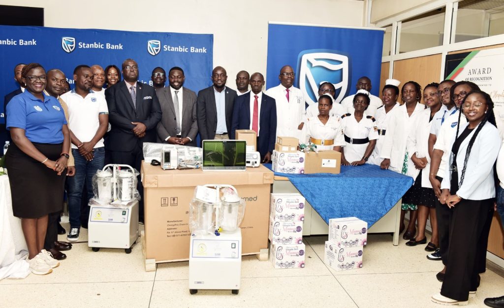 Different Stakeholders pose with medical equipment during the handover at Kawempe National Referral Hospital recently