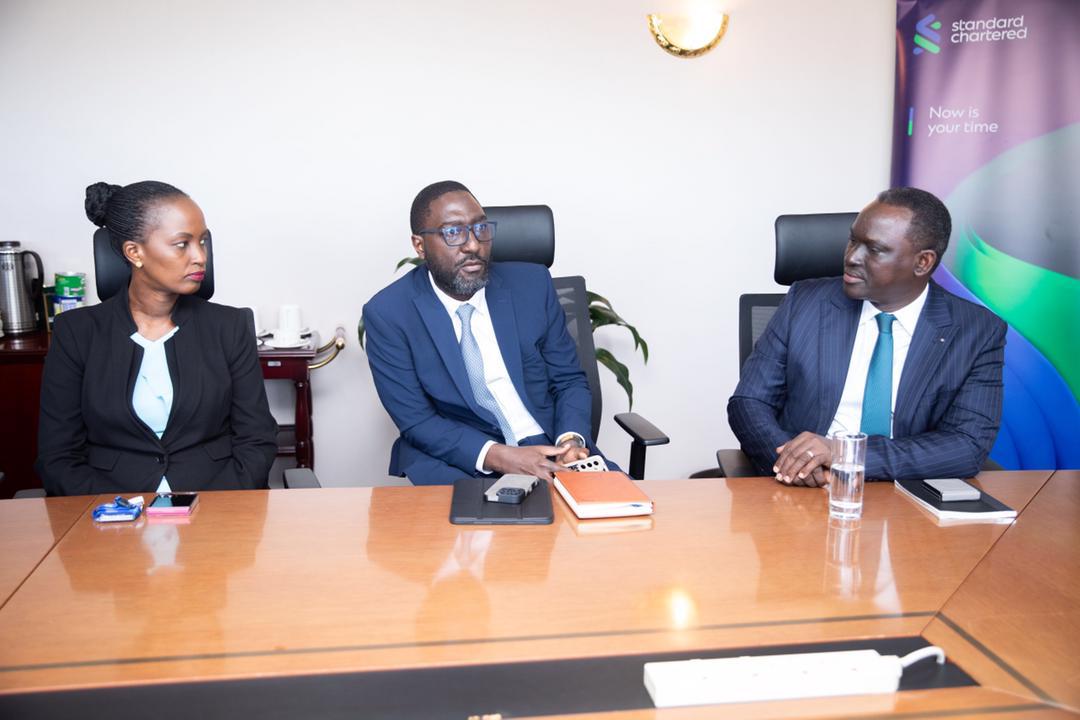 Stanchart executive director Charles Katongole and Prudence Byarugaba the Head of Risk chat with Kin